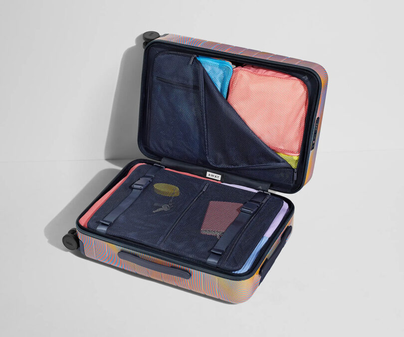 An open suitcase with clothes neatly packed inside, ready for the Resident Advisor Soundwave event.