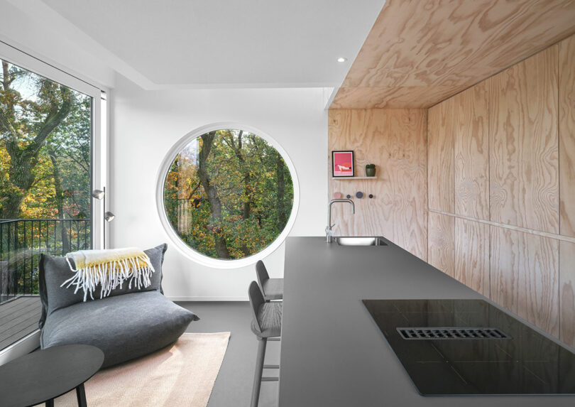 A circular window in a kitchen of small modern house.
