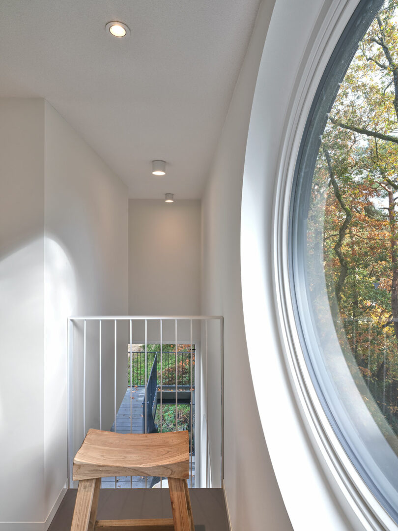 Interior view of a hallway overlooking downstairs with partial side window.