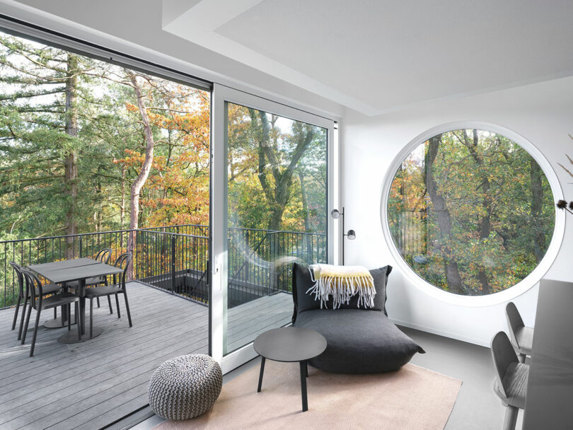 A living room with a circular window.