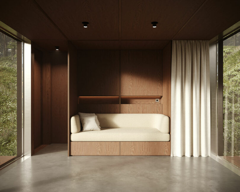 Modern minimalist interior with wooden walls, a built-in sofa, floor-to-ceiling windows, and sheer curtains.