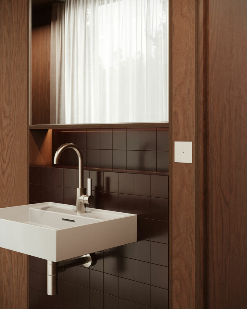 A bathroom with a sink and red tile.