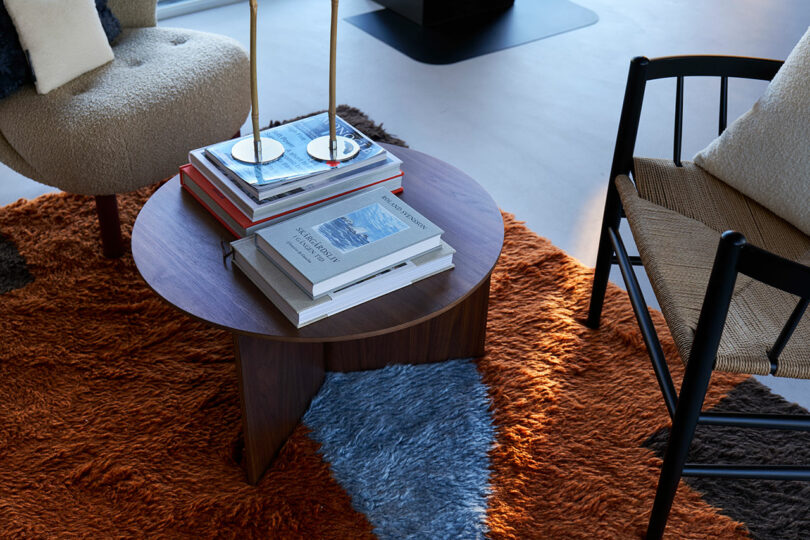 Cozy modern living room bathed in warm sunlight with stylish furnishings and colorful accents.