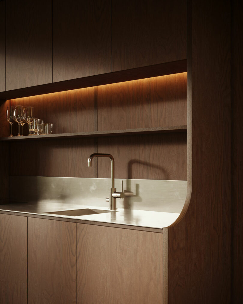 Modern kitchen corner with wooden cabinets and a built-in stainless steel sink.
