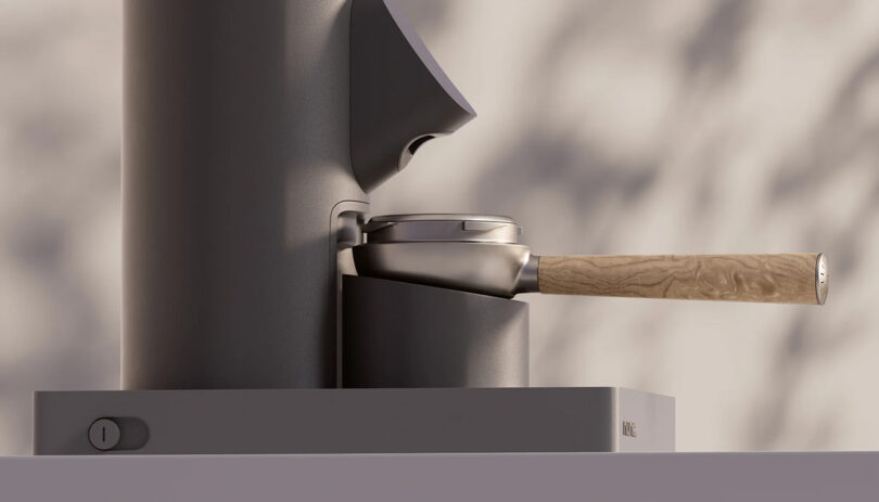 An espresso portafilter with a wooden handle attached to an AI-enhanced coffee machine.