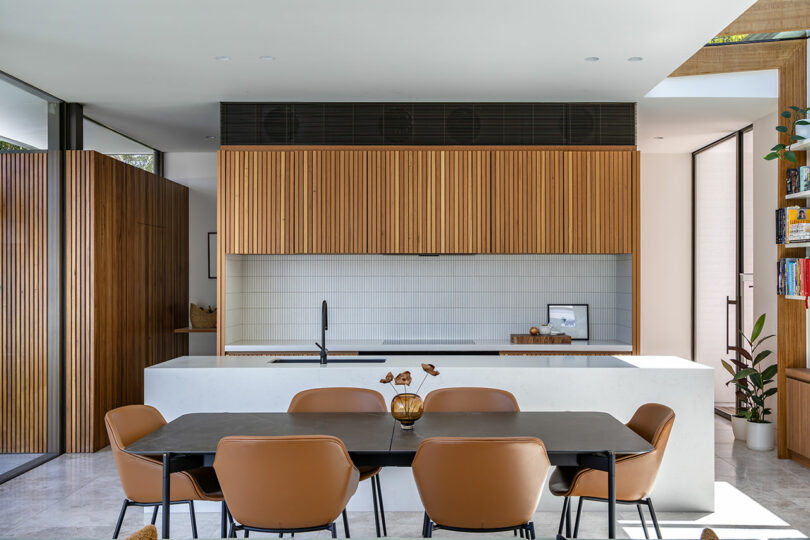 A dining table with brown chairs in a room.