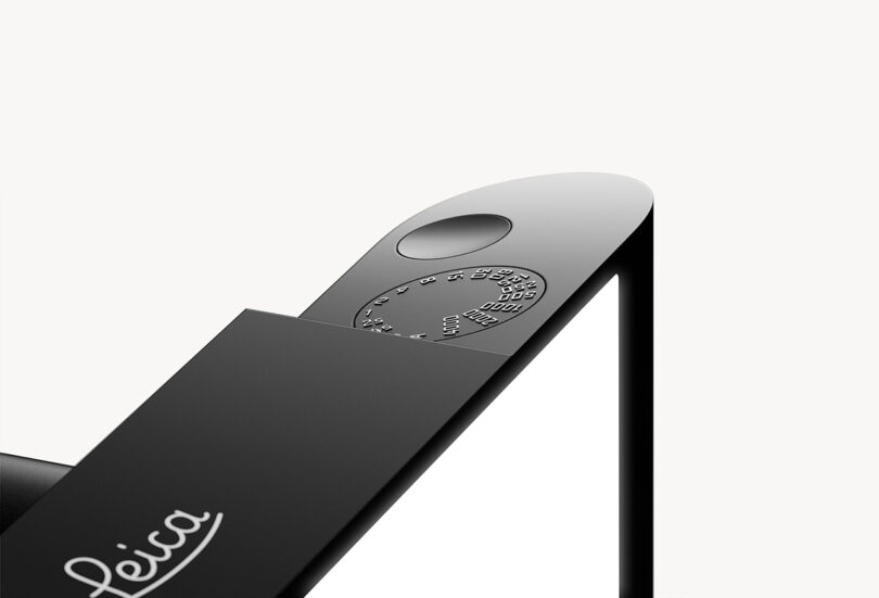 Corner shutter dial and button across top plate of black Leica M Reimagined Concept camera with Leica logo in the middle 