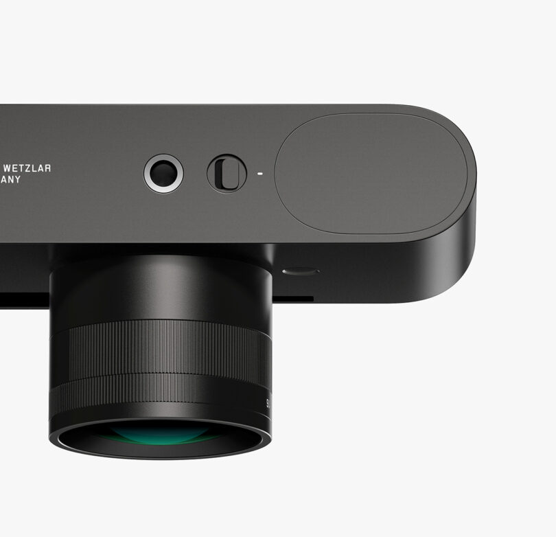 Bottom view of a black Leica M Reimagined Concept camera with a lens attached to it.