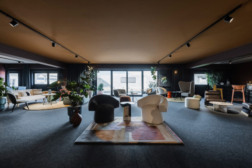 Modern NOA lounge area with contemporary furniture and large windows.